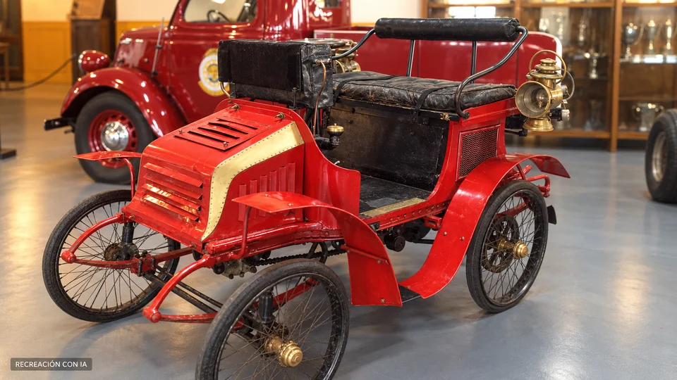 Recreación con IA de un automóvil antiguo rojo del Museo Eduardo Iglesias, con ruedas de rayos y farol de latón, basada en una fotografía de la exhibición de 2023.